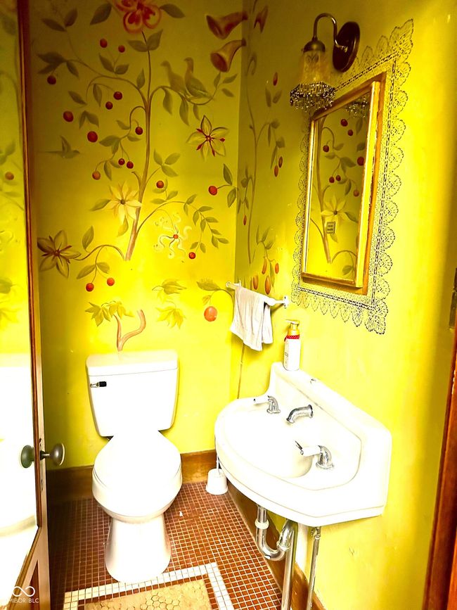 half bath featuring tile patterned floors, baseboards, toilet, and a sink | Image 10