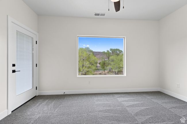 Carpeted empty room featuring baseboards, visible vents, and ceiling fan | Image 32