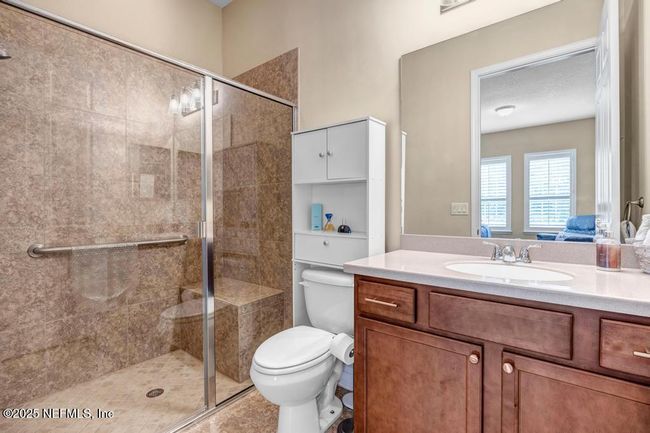 Full bathroom for back bedroom 4 with door to screened patio/pool | Image 28