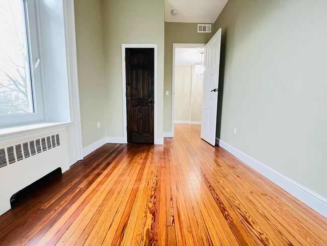 Opposite view of the second bedroom with closet. | Image 10