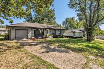 Ranch-style home with a front lawn and a garage | Image 2