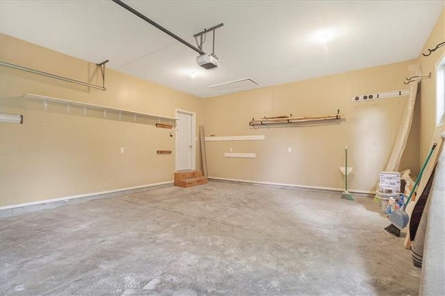 Garage featuring baseboards and a garage door opener | Image 34