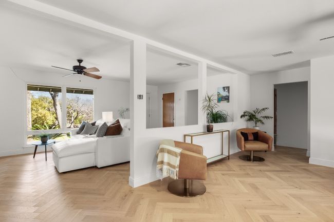 Sitting room featuring baseboards, visible vents, and ceiling fan | Image 7