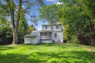 Lush greenery, including a well maintained lawn and mature plantings creates a natural canopy, providing shade and a soothing backdrop. | Image 1