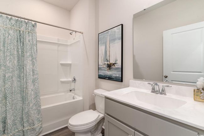 Full bathroom featuring shower / bath combo, vanity, and wood finished floors | Image 22