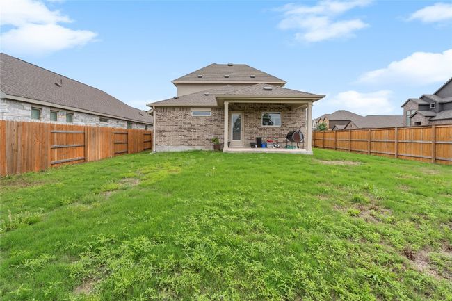 Back of house with a patio, a shingled roof, and brick siding | Image 36