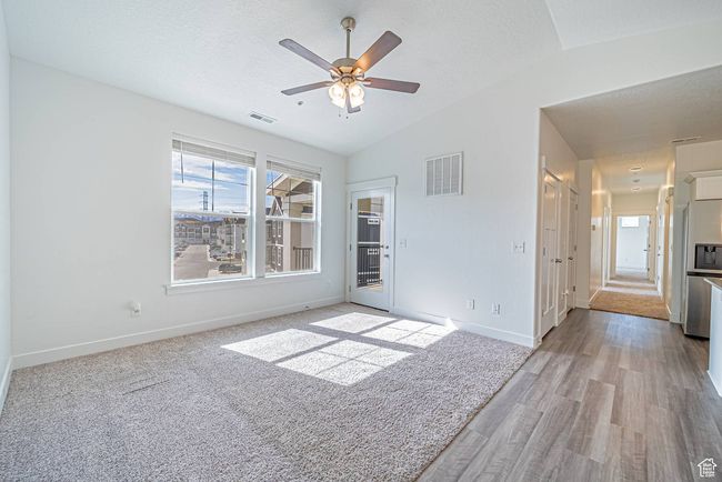 Spare room featuring baseboards, visible vents, and a wealth of natural light | Image 7