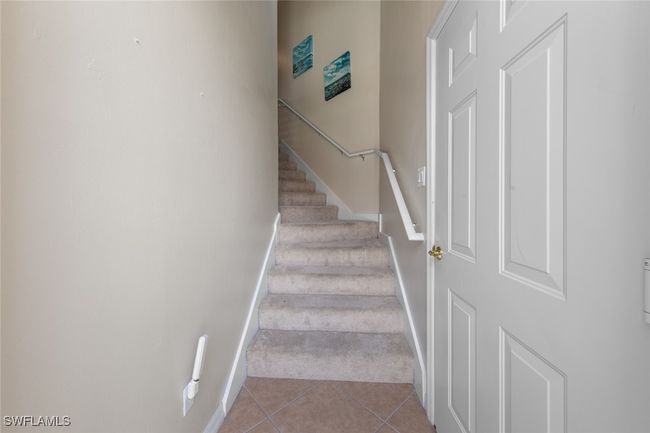 Staircase featuring carpet flooring, baseboards, and tile patterned floors | Image 28