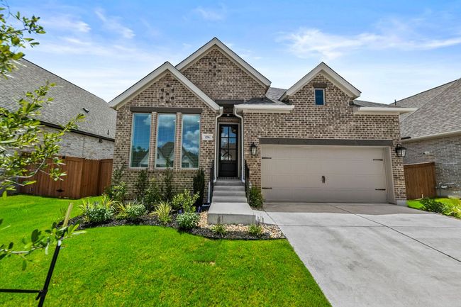View of front of property with a garage, brick siding, concrete driveway, and roof with shingles | Image 4