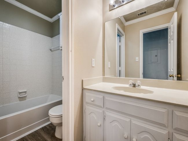 Full bathroom with crown molding, vanity, wood finished floors, and shower combination | Image 20