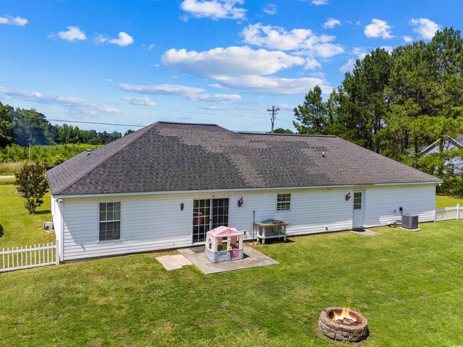 Rear view of house featuring an outdoor fire pit, a patio, and roof with shingles | Image 21