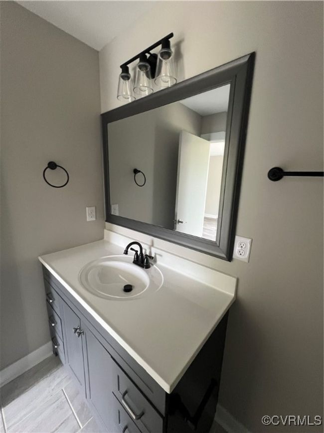 Bathroom featuring vanity and baseboards | Image 13