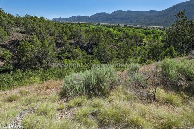 View of mountain background featuring a heavily wooded area | Image 9