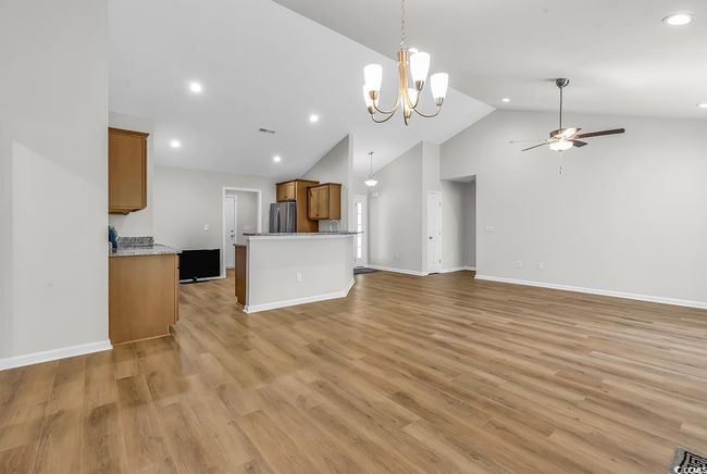 Unfurnished living room with ceiling fan, high vaulted ceiling, recessed lighting, light wood-type flooring, and baseboards | Image 30
