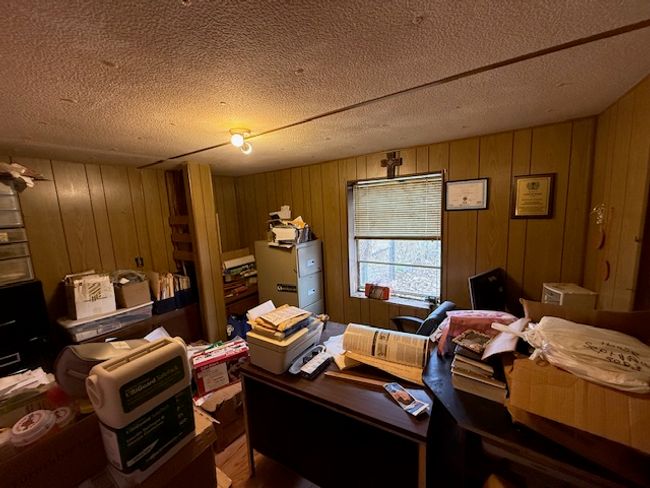 Home office with wooden walls, a textured ceiling, and wood-type flooring | Image 42