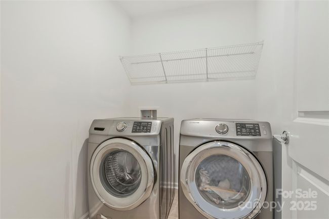 Laundry room with storage shelf. The washer and dryer comes with the home | Image 17