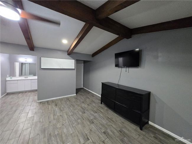 Unfurnished living room featuring baseboards and light wood-type flooring | Image 10