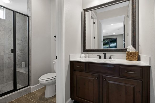 Full bath featuring toilet, vanity, a stall shower, and recessed lighting | Image 19