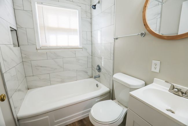Full bathroom with bathtub / shower combination, vanity, and toilet | Image 24