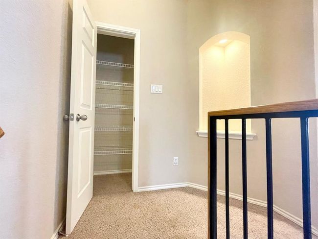 Corridor featuring carpet floors, arched walkways, and baseboards | Image 9