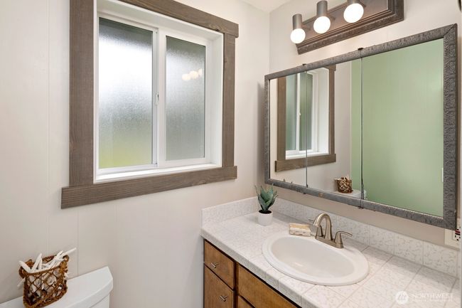 Bathroom with updated shower surround and vanity sink. | Image 18