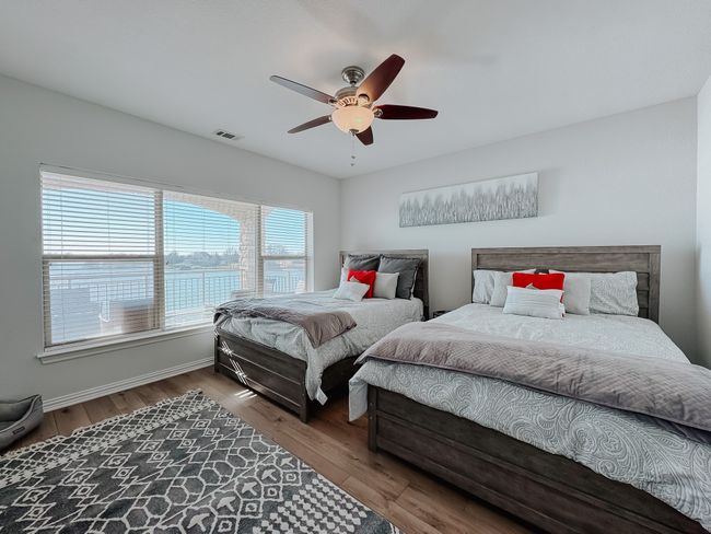 Primary bedroom with fantastic lake views. New flooring and paint. | Image 17