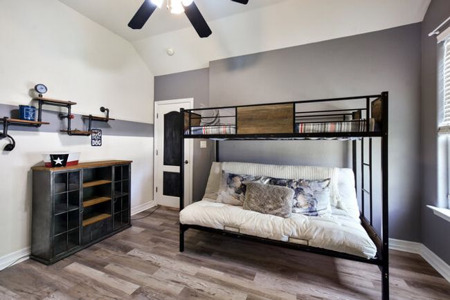 Bedroom with vaulted ceiling and wood finished floors | Image 27