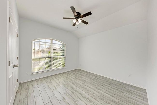 second and third bedroom with ceiling fan, baseboards, vaulted ceiling, and light wood-style floors | Image 26
