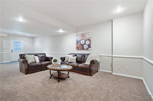 Lower level game room with chair rail, recessed lighting, plush carpet and walk out access. | Image 19