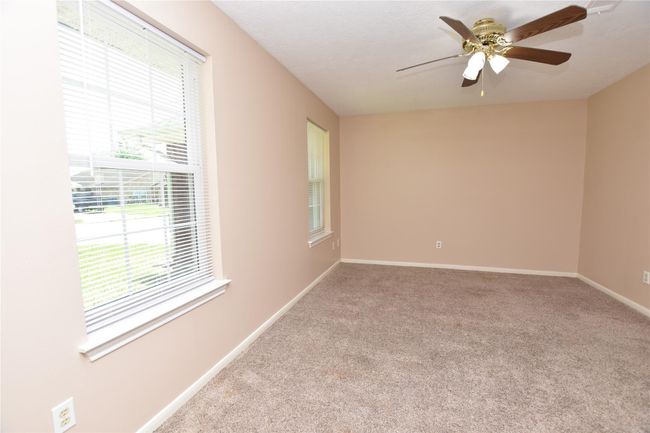 This home features two well-appointed secondary bedrooms, each offering ample space and natural light, making them ideal for family members, guests, or as versatile home office. | Image 19