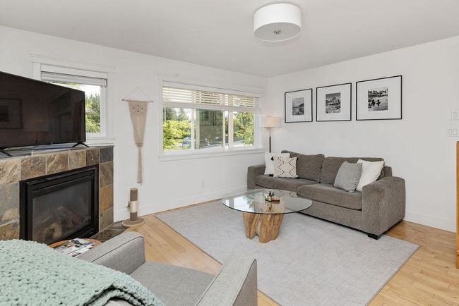 Living room with maple hardwood flooring and mountain/ocean views | Image 6