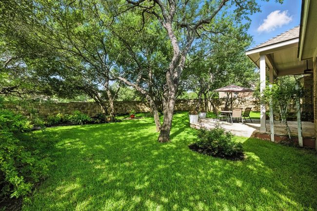 Fenced backyard with a patio. Yard is an immaculate haven | Image 30