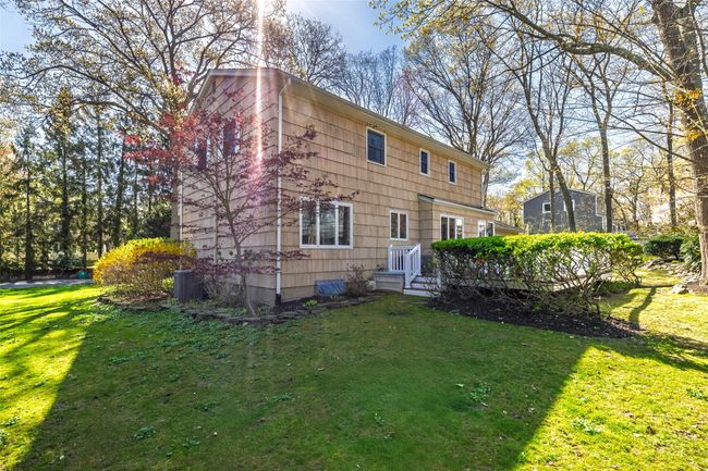 Rear view of property with a deck and a lawn | Image 36