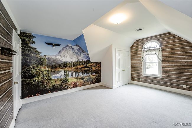 Additional living space with carpet, lofted ceiling, a mountain view, baseboards, and wooden walls | Image 30