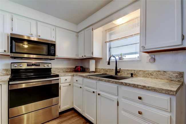 19. FULLY UPDATED Kitchen (9.2' x 8.9') w Kitchen Sink Window! HIGH QUALITY Stainless Appliances, White Cabinets, Gorgeous Counters. | Image 19