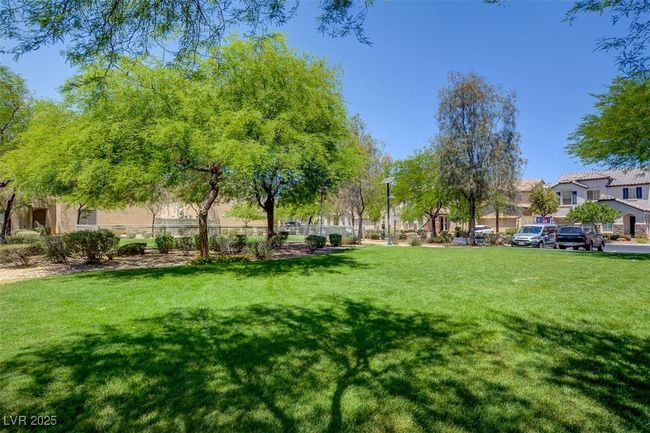 View of community with fence and a yard | Image 27