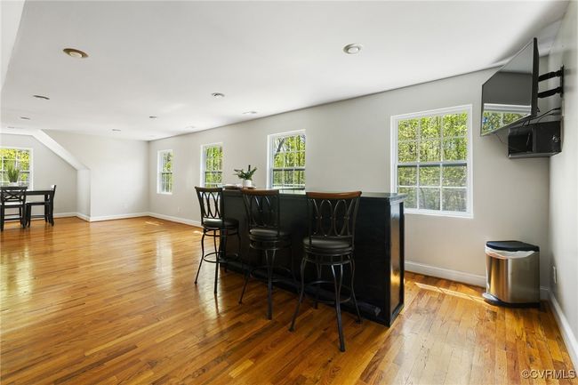 Rec room is a light filled space with gorgeous hardwood floors | Image 27