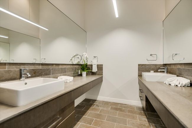 Dual vanities with modern fixtures provide both style and space for everyday convenience in the primary bathroom. | Image 22