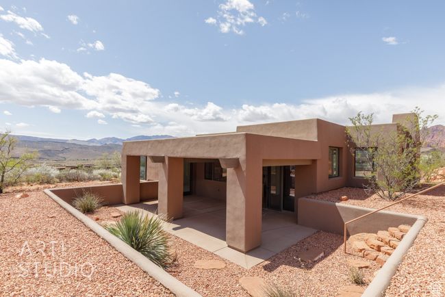 Rear view of house with a patio area, stucco siding, and a mountain view | Image 44