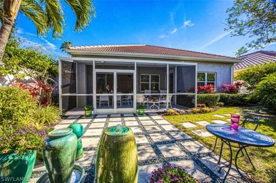 Back of property featuring a patio area and a sunroom | Image 1