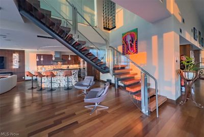 Staircase featuring dark hardwood / wood-style flooring and a towering ceiling | Image 3