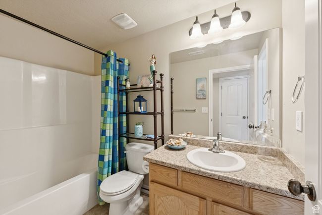 Full bath featuring vanity and shower / bath combo | Image 33