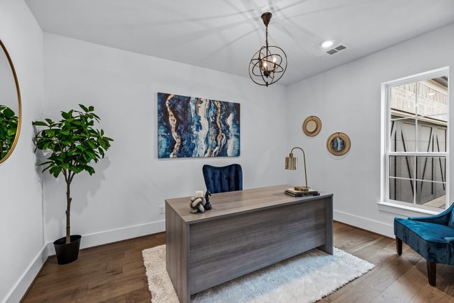 Office space featuring a notable chandelier and dark wood-type flooring | Image 7