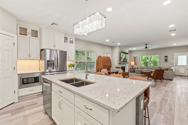 Kitchen opens to living and dining for effortless flow. | Image 6