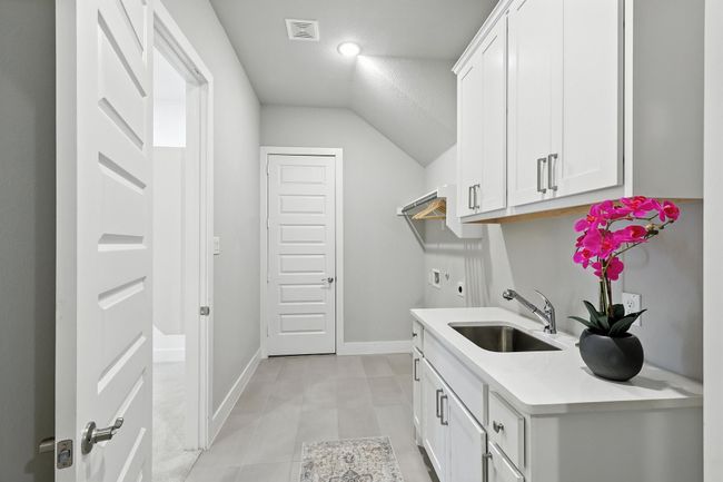 Washroom featuring hookup for a washing machine, electric dryer hookup, and cabinet space | Image 19