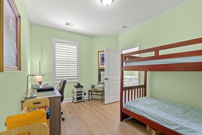 Bedroom with baseboards, visible vents, multiple windows, and light wood-type flooring | Image 5