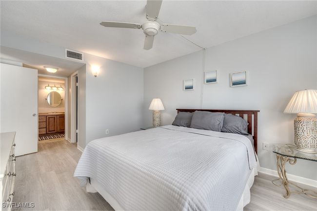 Bedroom with connected bathroom, light hardwood / wood-style flooring, and ceiling fan | Image 26