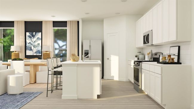 Kitchen featuring appliances with stainless steel finishes, white cabinetry, an island with sink, a kitchen breakfast bar, and decorative backsplash | Image 4