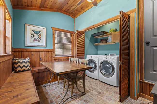 Clothes washing area featuring a wainscoted wall, wooden walls, wood ceiling, and laundry area | Image 29