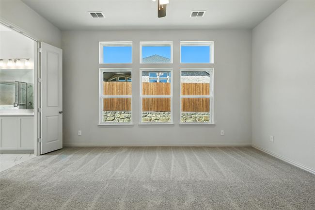 Carpeted spare room with ceiling fan and plenty of natural light | Image 18